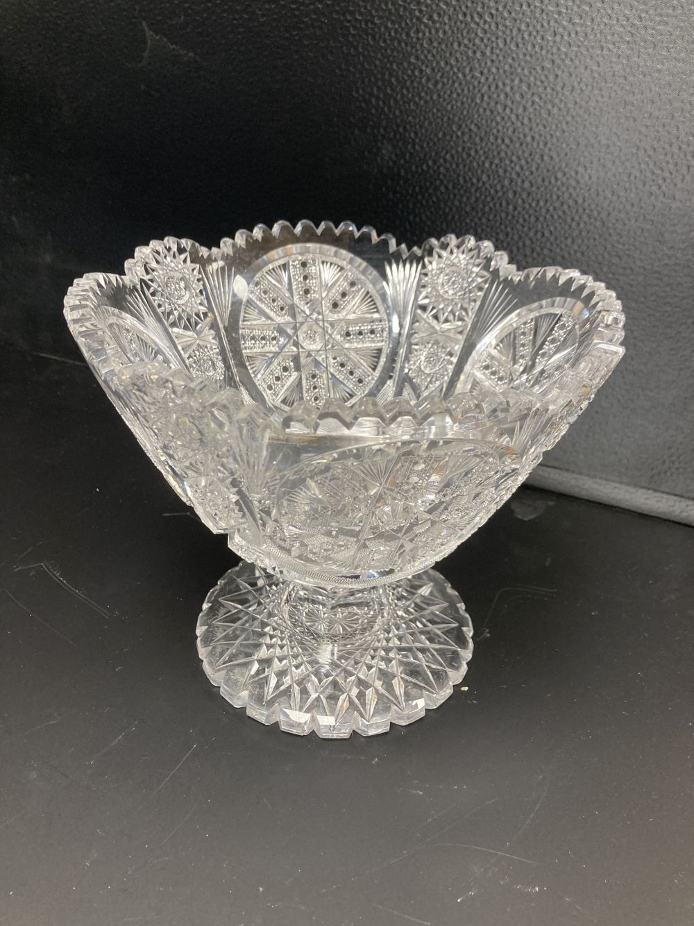 An American or Bohemian brilliant cut glass pedestal bowl and large dish, late 19th century, dish 36cm